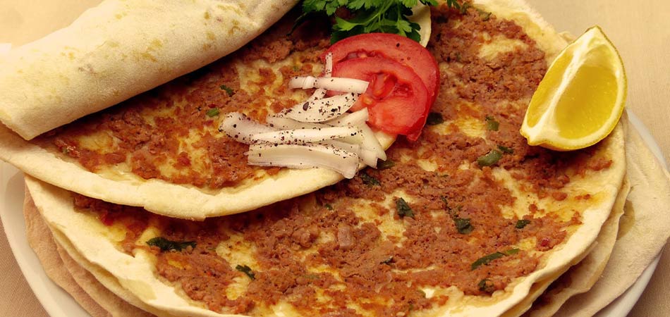 Lahmacun, very thin crispy pizza dough with spicy meat on top