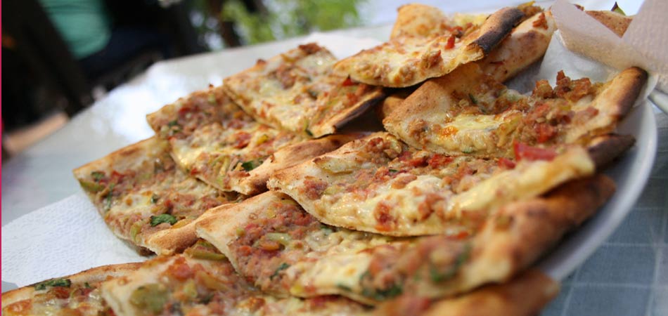 Pide is Turkish flatbread topped with meat or cheese